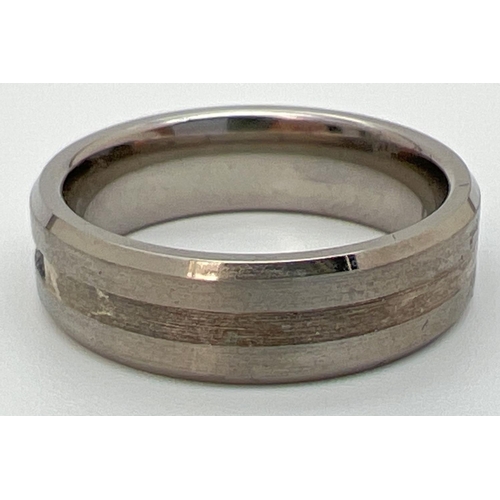 1089 - A brand new in box man's Titanium and Sapphire band ring. Two tone titanium with 5 round cut channel... 