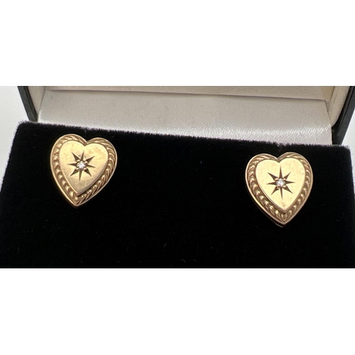 1090 - A pair of vintage 9ct gold heart shaped stud earrings each set with a central small round cut diamon... 