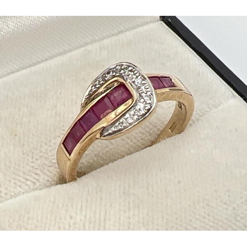 1001 - A 9ct gold ruby and diamond set buckle style dress ring. Band channel set with 5 square cut rubies. ... 