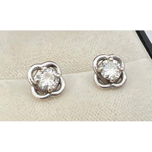 1093 - A pair of 9ct white gold modern design moissanite set stud earrings. Each earring set with a .25ct r... 