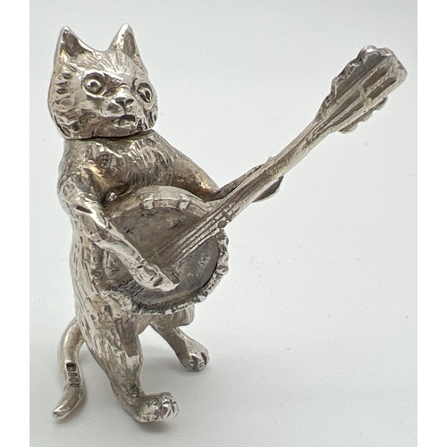 1145 - An Edwardian silver novelty container modelled as a cat playing a banjo, with hinged head. Import ha... 