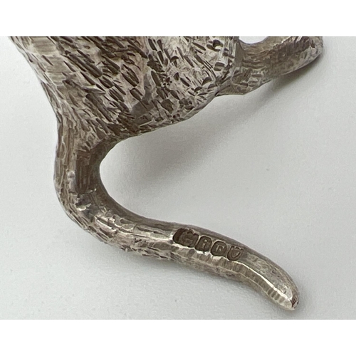 1147 - An Edwardian silver novelty container modelled as a cat playing the clarinet, with hinged head. Impo... 