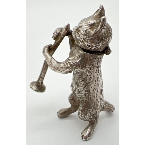 1147 - An Edwardian silver novelty container modelled as a cat playing the clarinet, with hinged head. Impo... 