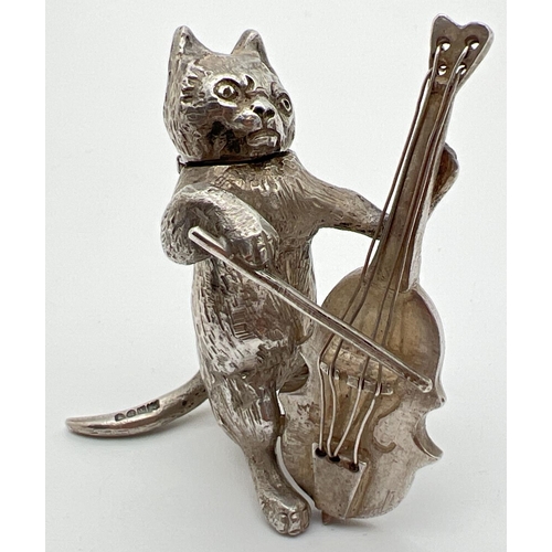 1149 - An Edwardian silver novelty container modelled as a cat playing a cello, with hinged head. Import ha...