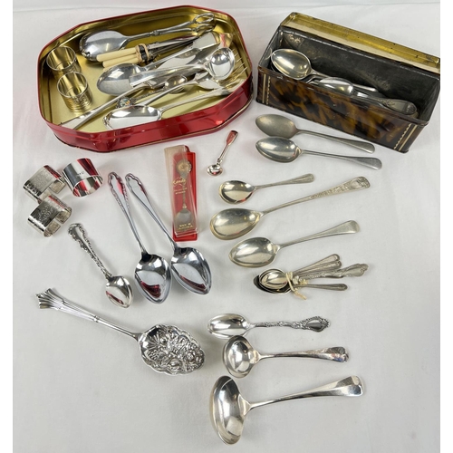 1154 - A collection of silver and silver plate cutlery, serving spoons and napkin rings. To include example... 