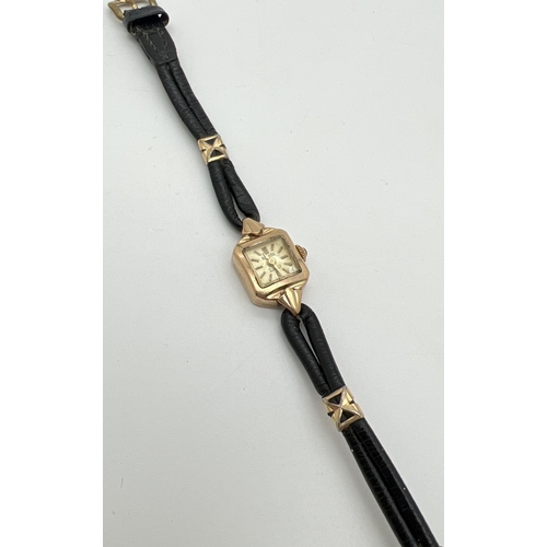 1127 - A vintage 9ct gold ladies wristwatch with black leather strap and gold decorative clips by Bernex. H... 