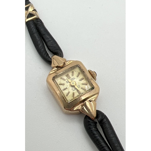 1127 - A vintage 9ct gold ladies wristwatch with black leather strap and gold decorative clips by Bernex. H... 