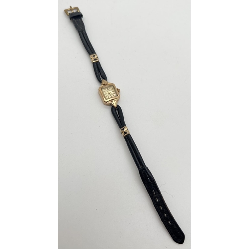 1127 - A vintage 9ct gold ladies wristwatch with black leather strap and gold decorative clips by Bernex. H... 