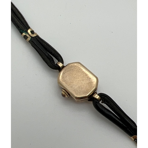 1127 - A vintage 9ct gold ladies wristwatch with black leather strap and gold decorative clips by Bernex. H... 