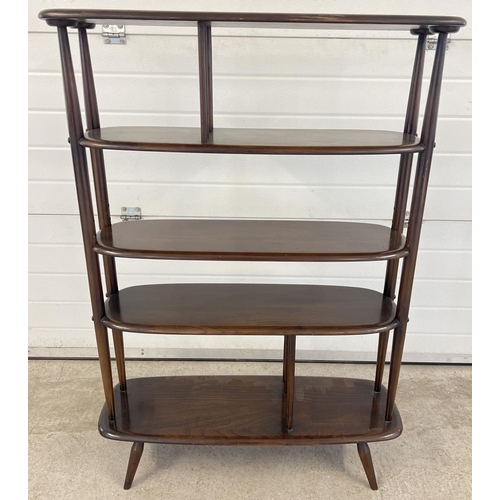 1338 - A vintage 1960's Ercol dark wood room divider with 5 curved edge shelves. Raised on 4 small splayed ... 