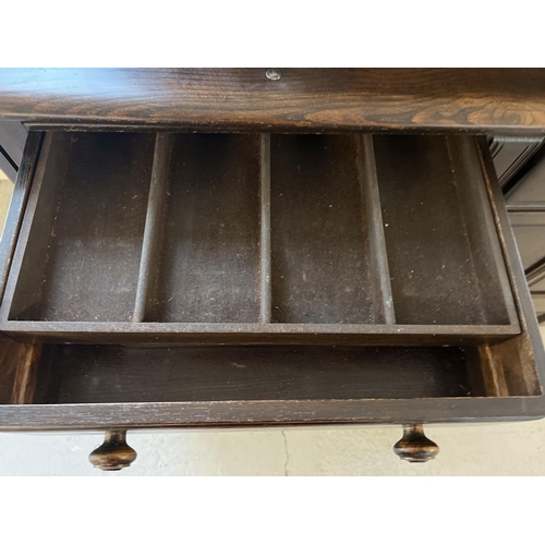 1339 - A vintage Ercol small double dresser in dark wood. Two shelves to top with shaped sides. 2 door and ... 