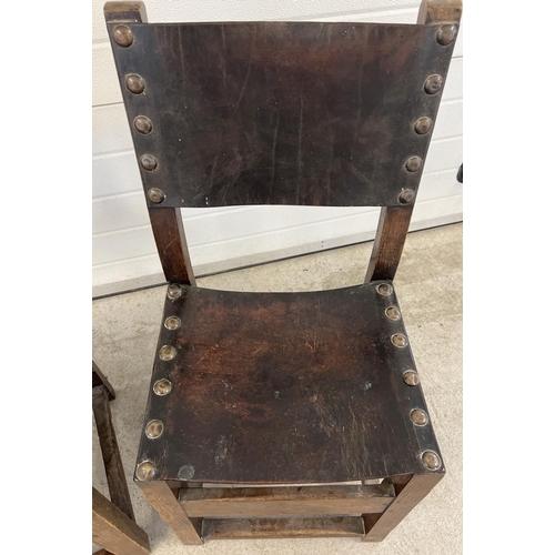 1340 - 2 dark oak Arts & Crafts style wooden block chairs with leather backs and seats. Large brass stud de... 