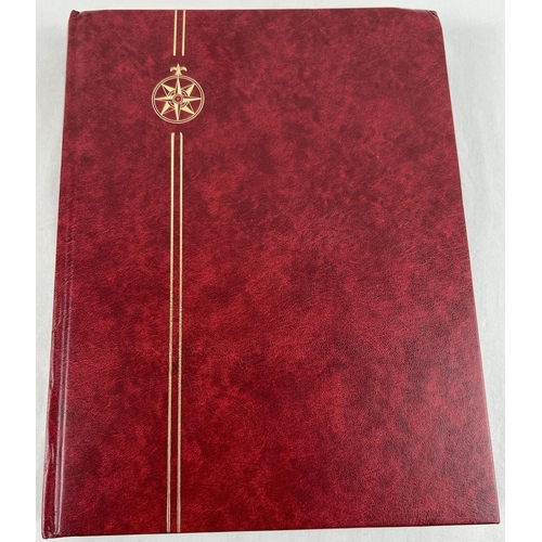 79 - A red stamp album containing a collection of world stamps mostly in mint condition. To include examp... 