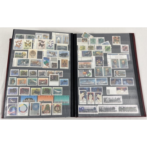 79 - A red stamp album containing a collection of world stamps mostly in mint condition. To include examp... 