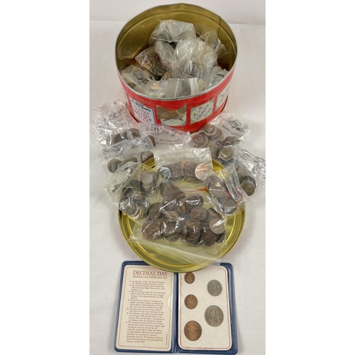 61 - A tin of vintage British and foreign coins in varying conditions. British coins to include sovereign... 