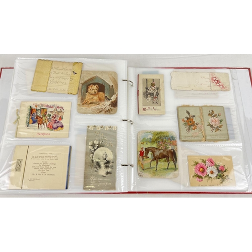 179 - A large red album containing 312 assorted Victorian & Edwardian greetings cards. In varying shapes, ... 