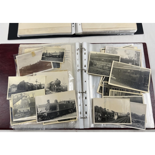 196 - 2 albums of vintage black and white photographs of steam trains.