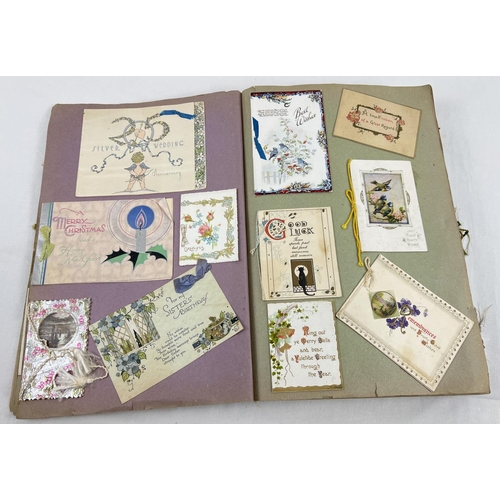 198 - An album containing 230+ assorted Victorian & Edwardian greetings cards. Each card fixed onto scrap ... 