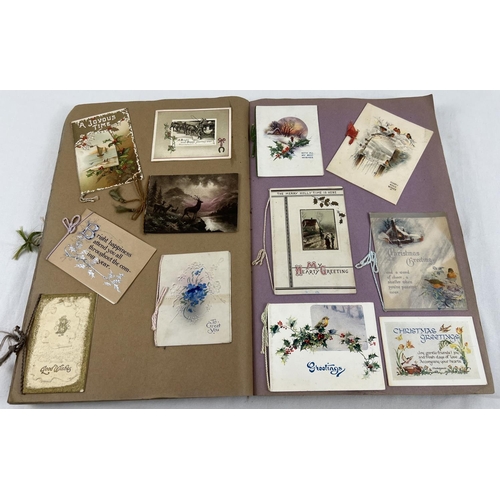 198 - An album containing 230+ assorted Victorian & Edwardian greetings cards. Each card fixed onto scrap ... 