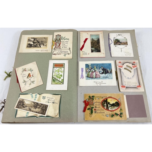 198 - An album containing 230+ assorted Victorian & Edwardian greetings cards. Each card fixed onto scrap ... 