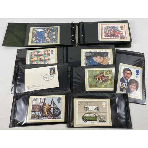 1211 - An album containing 100+ assorted stamped first day issue PHQ cards.