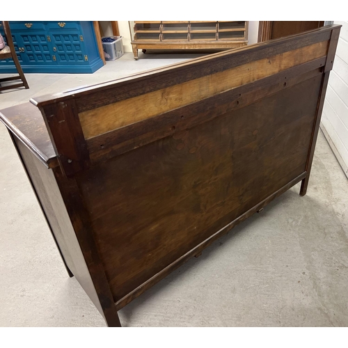 1356 - A vintage dark wood Old Charm style sideboard with carved detail and panelled doors. 2 cupboards to ... 