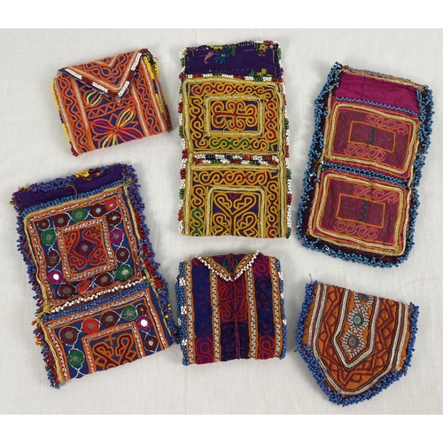 1309 - 6 Central Asian heavily embroidered wrap pouches, in varying colours, sizes and designs. Some with b... 