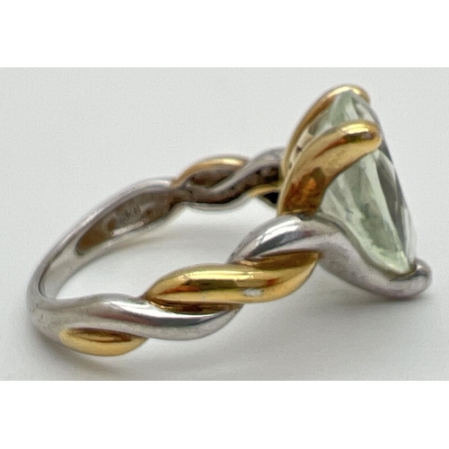 1009 - A modern design duo coloured silver cocktail ring set with a teardrop cut green amethyst. With twist... 