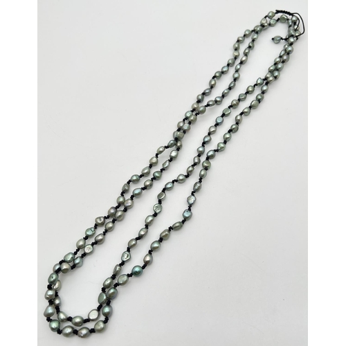 1010 - A 28 inch string of double knotted green freshwater pearls with pull cord to extend to 31 inches.