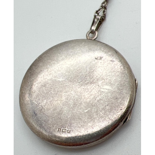 1014 - A vintage silver locket with foliate design engraving to front, on a 24