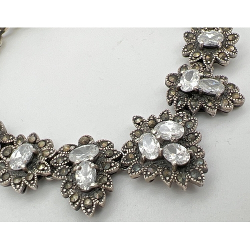 1029 - A silver Gothic style marcasite and clear stone set bracelet with floral design panels. Silver marks... 