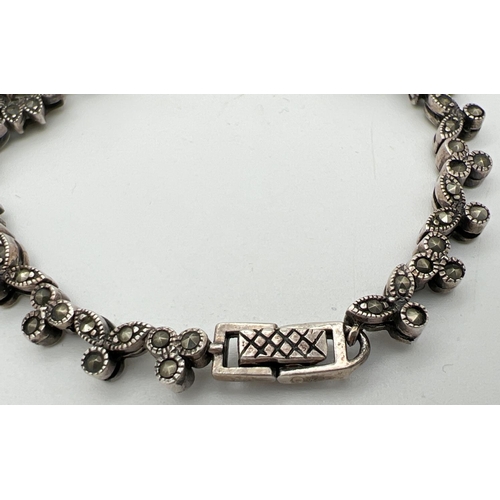 1029 - A silver Gothic style marcasite and clear stone set bracelet with floral design panels. Silver marks... 