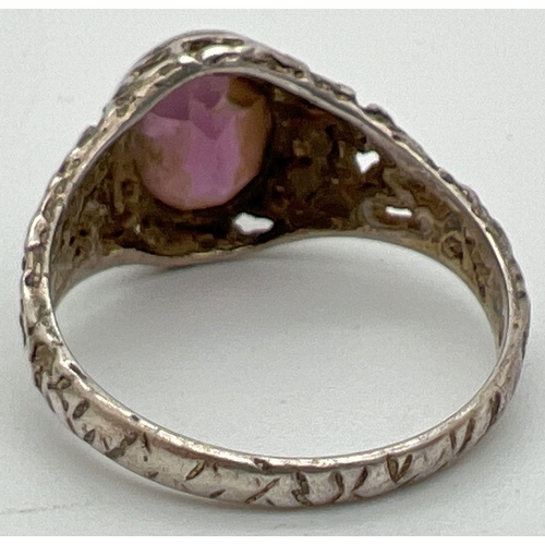 1035 - A vintage silver dress ring with bark effect mount set with an oval cut central amethyst stone. Hall... 