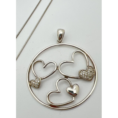 1038 - 3 items of silver diamond set heart design jewellery. A heart shaped floating pendant set with 3 sma... 