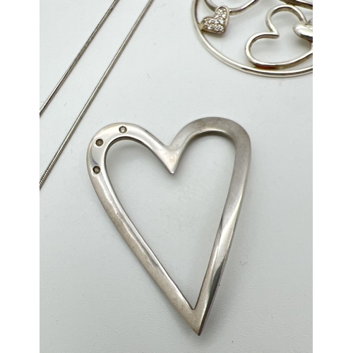 1038 - 3 items of silver diamond set heart design jewellery. A heart shaped floating pendant set with 3 sma... 