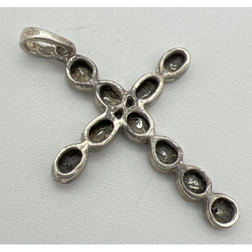 1041 - A silver cross shaped pendant set with 10 rough cut diamonds. Each diamond approx. 2mm x 3mm. Each s... 