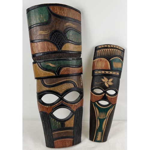 1203 - 2 African carved wooden masks with carved and coloured detail. Largest approx. 62cm long.