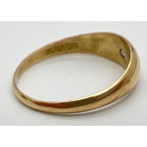 1043 - A men's 18ct gold Gypsy style band ring set with a single round cut diamond. Full hallmarks to insid... 