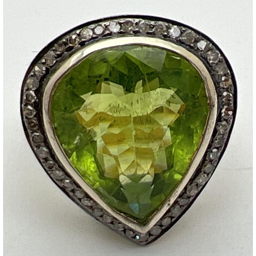 1045 - A 14ct gold peridot and diamond set cocktail ring. Central large teardrop cut peridot (approx. 18mm ... 