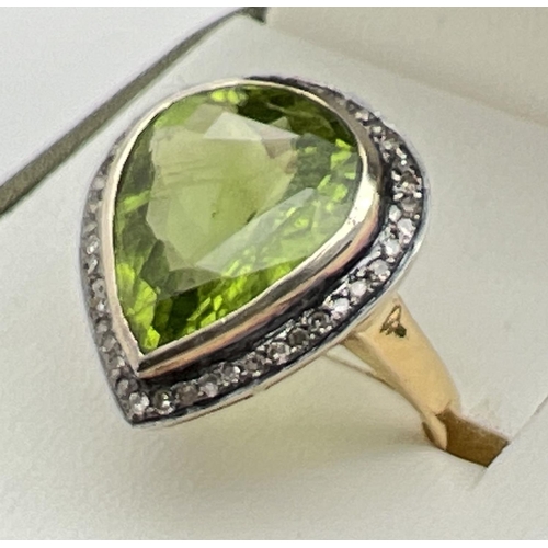 1045 - A 14ct gold peridot and diamond set cocktail ring. Central large teardrop cut peridot (approx. 18mm ... 