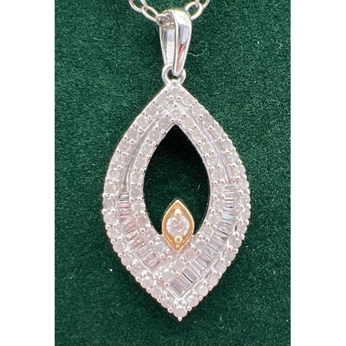 1047 - A 9ct white gold marquise shaped pendant with yellow gold accent, set with 23 baguette and 61 round ... 