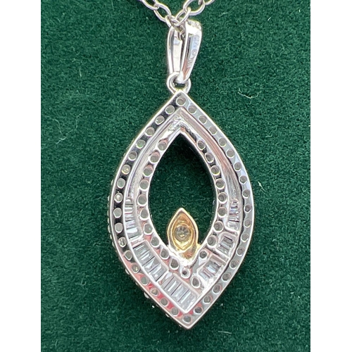 1047 - A 9ct white gold marquise shaped pendant with yellow gold accent, set with 23 baguette and 61 round ... 