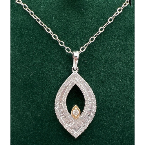 1047 - A 9ct white gold marquise shaped pendant with yellow gold accent, set with 23 baguette and 61 round ... 