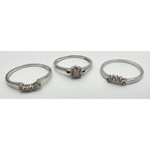 1048 - A 9ct white gold and diamond bridal set of 3 rings. Central small diamond cluster ring with 2 eterni... 