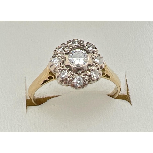 1001 - A vintage 18ct gold diamond cluster style ring set with 9 round cut diamonds. Total diamond approx. ... 