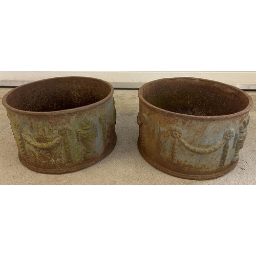 1325 - A pair of vintage round shaped cast iron garden planters with embossed floral swag design. Approx. 2... 