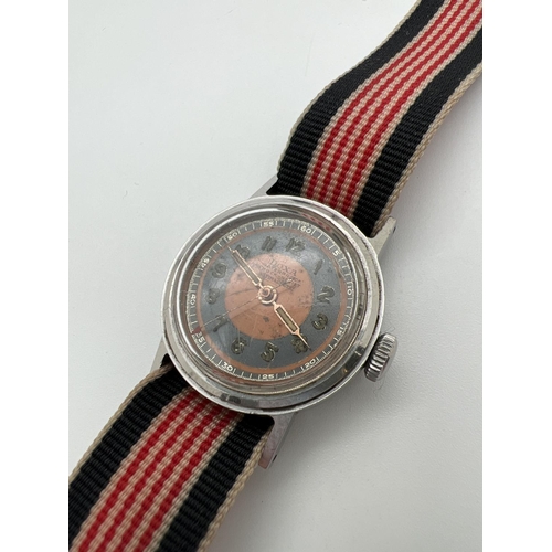 1106 - A vintage Doxa Shock proof wristwatch with canvas strap. Blue and orange face with luminous hands. N... 