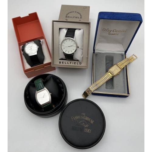 1107 - 4 boxed vintage and modern watches. The Famous Grouse watch with green leather strap, a slimline men... 