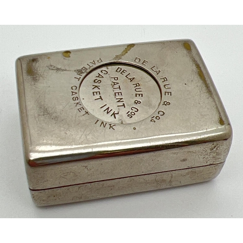 1268 - An early 20th century De La Rue & Cos travelling casket inkwell. Nickel plated inkwell with hinged l... 