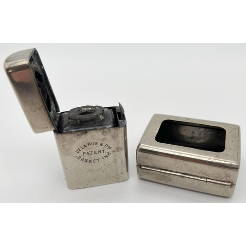 1268 - An early 20th century De La Rue & Cos travelling casket inkwell. Nickel plated inkwell with hinged l... 